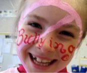 girl with bullying sign on face