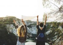 Two girls making the peace sign. What action will you take on International Peace Day?
